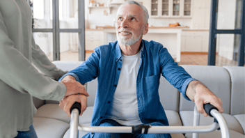 man using Zimmer frame at home 